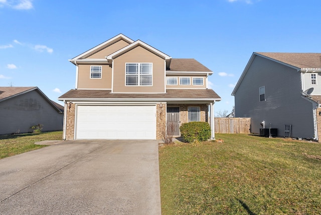 traditional-style house featuring a front yard, fence, concrete driveway, a garage, and brick siding