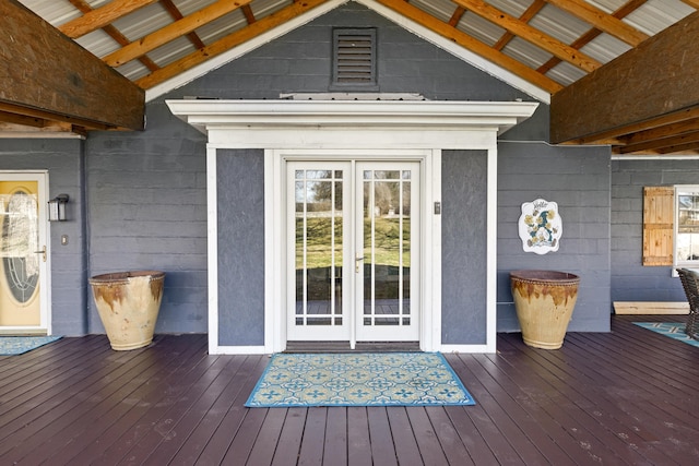 view of exterior entry with french doors and a deck