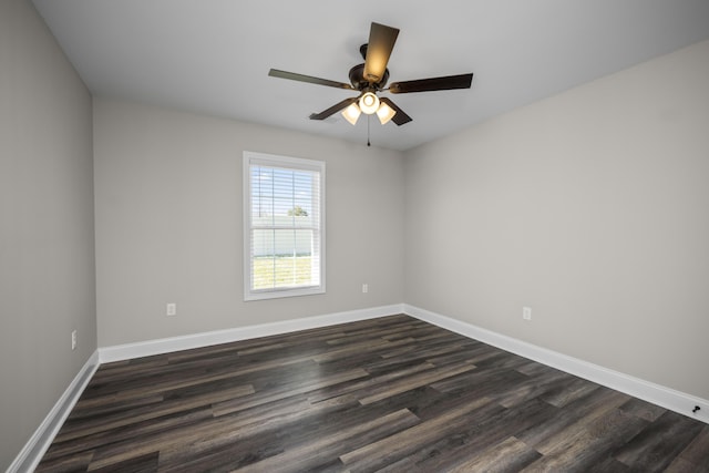 unfurnished room with ceiling fan, dark wood-type flooring, and baseboards