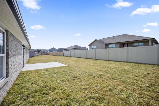 view of yard featuring a patio area and a fenced backyard