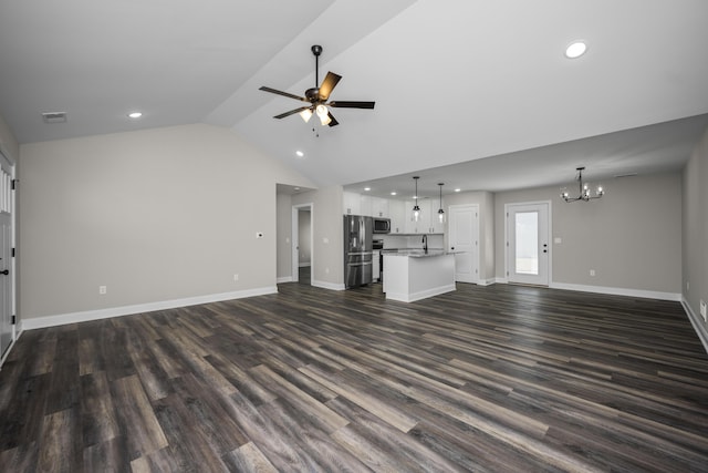 unfurnished living room with baseboards, dark wood finished floors, recessed lighting, vaulted ceiling, and ceiling fan with notable chandelier