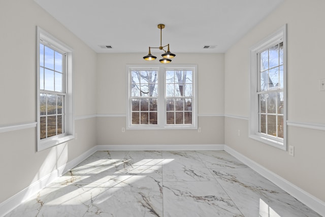 unfurnished dining area with visible vents, baseboards, and a healthy amount of sunlight