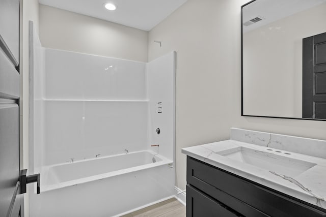 full bathroom with vanity, wood finished floors, visible vents, recessed lighting, and shower / tub combination