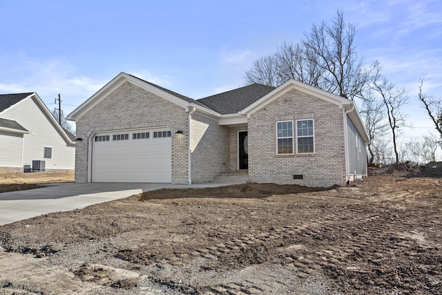 single story home featuring central AC unit, driveway, an attached garage, crawl space, and brick siding