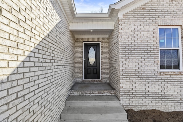 property entrance with brick siding