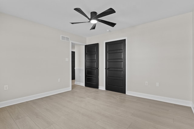 unfurnished bedroom with visible vents, baseboards, and light wood-style floors