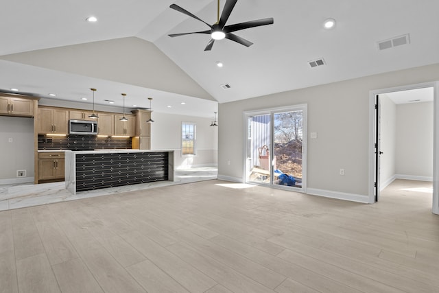 unfurnished living room featuring visible vents, light wood-style flooring, baseboards, and a ceiling fan