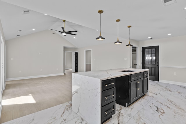 kitchen with ceiling fan, visible vents, open floor plan, and dark cabinetry