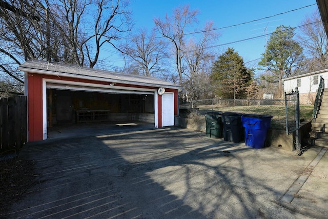 detached garage featuring fence