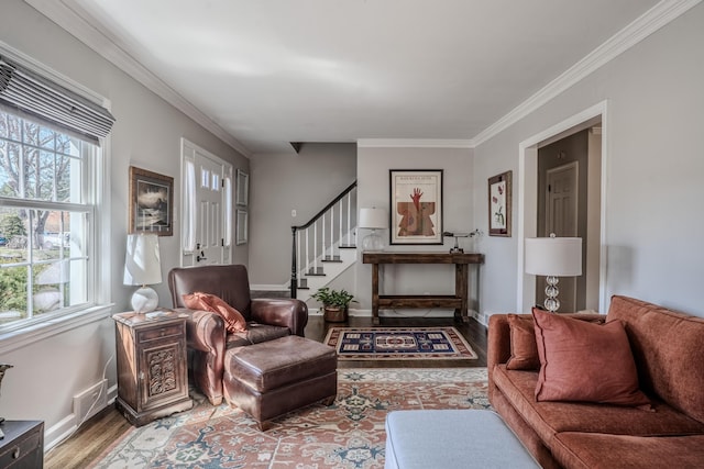 living area with stairway, ornamental molding, baseboards, and wood finished floors