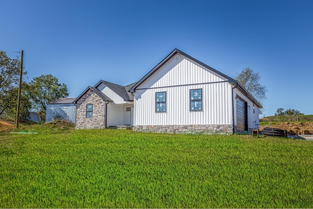 exterior space with a front lawn and board and batten siding