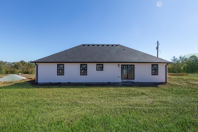 back of property featuring a yard, roof with shingles, and crawl space