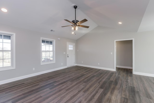 unfurnished living room featuring visible vents, baseboards, vaulted ceiling, a ceiling fan, and dark wood-style flooring