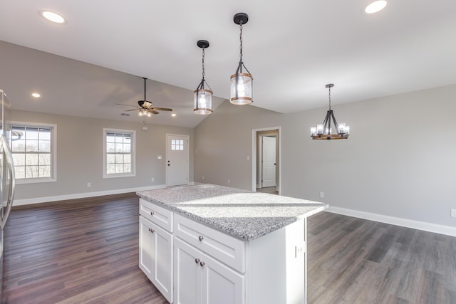 kitchen with dark wood finished floors, open floor plan, white cabinets, and vaulted ceiling