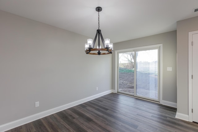 spare room with visible vents, an inviting chandelier, dark wood-type flooring, and baseboards