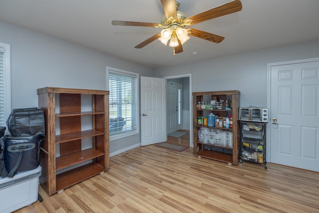 misc room featuring baseboards, light wood-type flooring, and ceiling fan