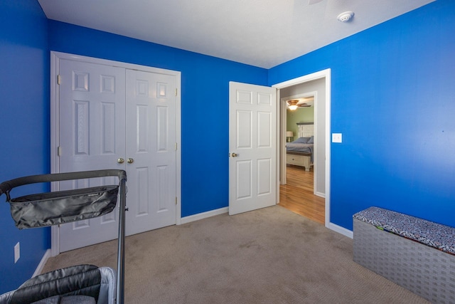 bedroom featuring a closet, baseboards, and carpet