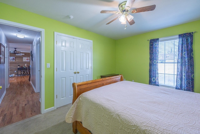 bedroom featuring a closet, baseboards, ceiling fan, and carpet floors