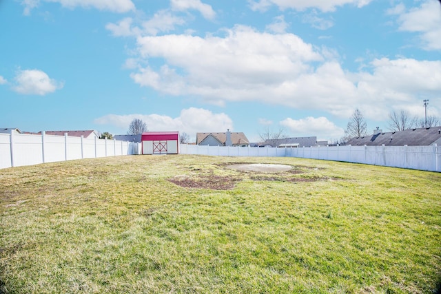 view of yard featuring an outbuilding and a fenced backyard