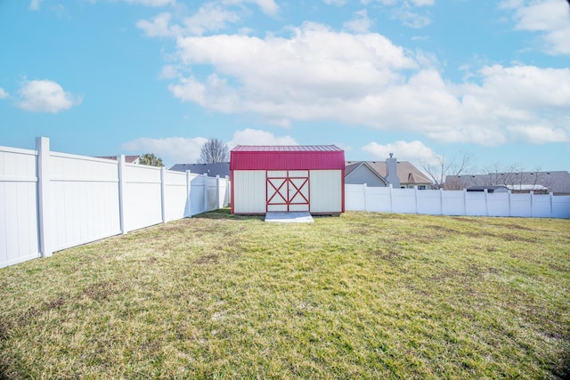 view of yard with a fenced backyard, a storage shed, and an outdoor structure