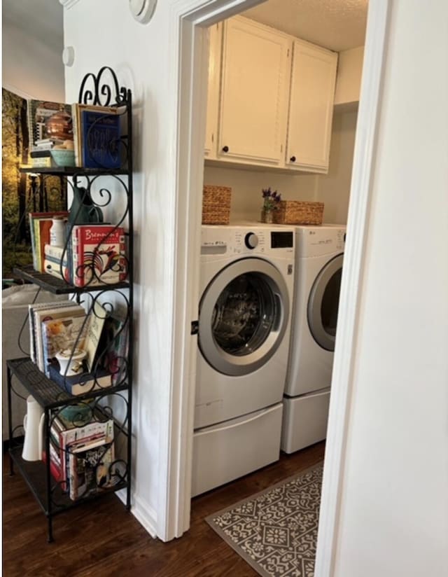 clothes washing area featuring cabinet space, dark wood-style floors, separate washer and dryer, and a textured ceiling