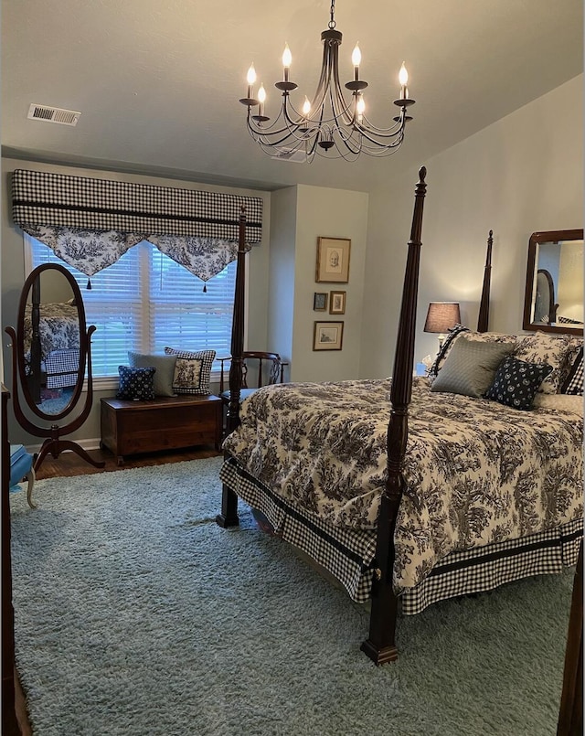 bedroom with visible vents and a notable chandelier