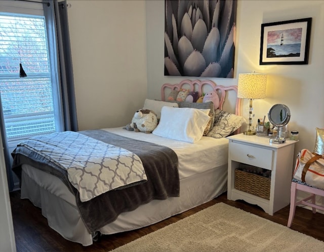 bedroom featuring multiple windows and wood finished floors