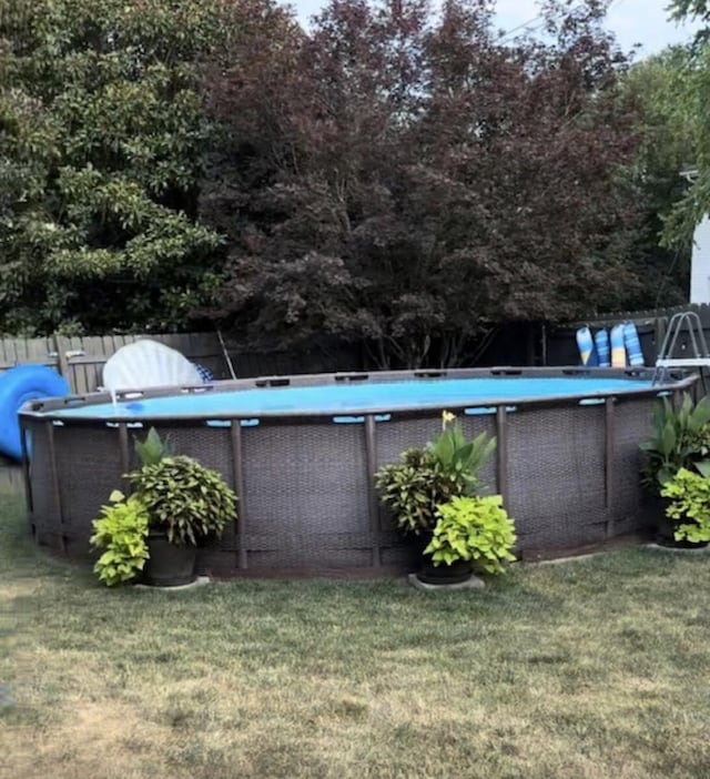 pool with a lawn and fence