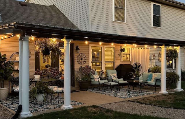 exterior space with a patio area and a shingled roof