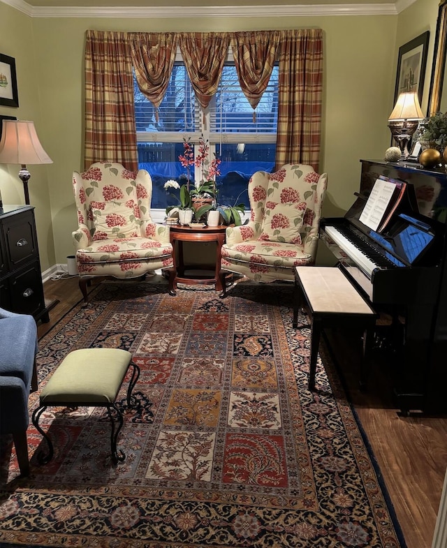 living area featuring wood finished floors and ornamental molding