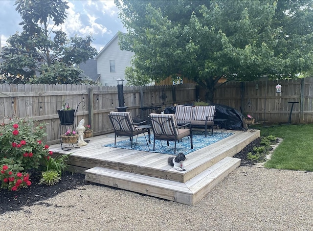 wooden deck featuring outdoor lounge area and a fenced backyard