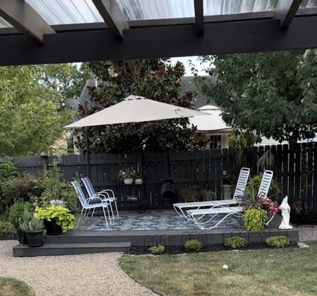 wooden deck with a lawn and fence