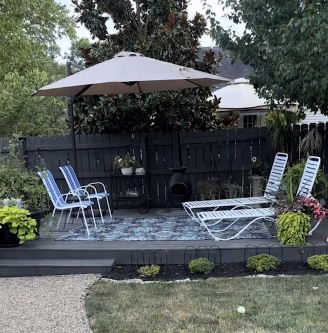 deck with a yard and fence