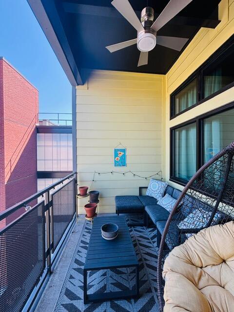 balcony featuring an outdoor living space and ceiling fan