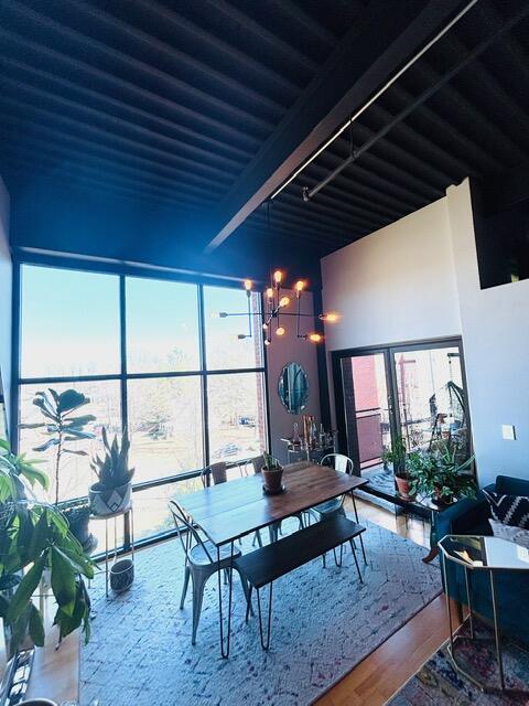 interior space with beam ceiling, wood finished floors, and a wealth of natural light