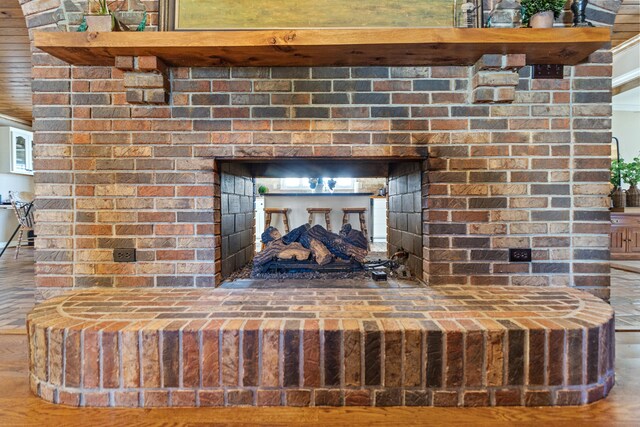 interior details featuring wood finished floors and a fireplace