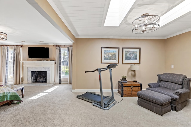 workout area featuring a notable chandelier, carpet floors, crown molding, a premium fireplace, and baseboards