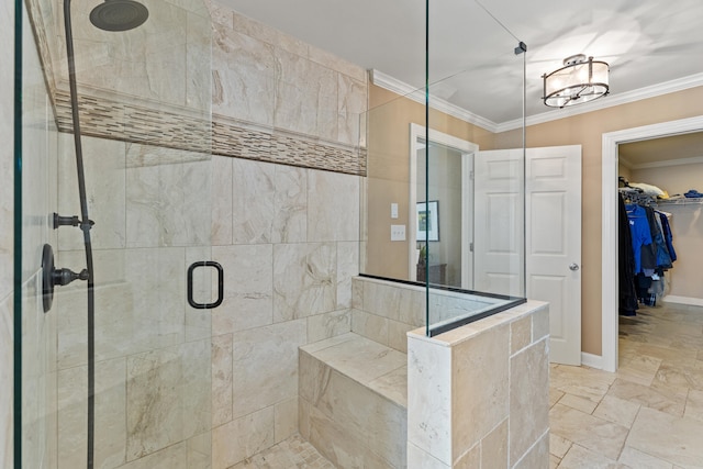 full bath featuring a spacious closet, a shower stall, crown molding, and baseboards