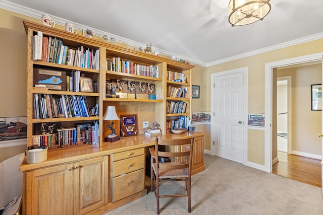 home office with ornamental molding, built in desk, a chandelier, and light carpet