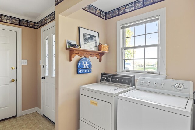 laundry area with baseboards, light floors, washing machine and dryer, and laundry area