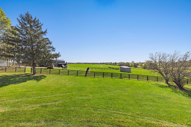 view of yard featuring a rural view and fence