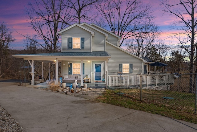 farmhouse inspired home with covered porch and concrete driveway