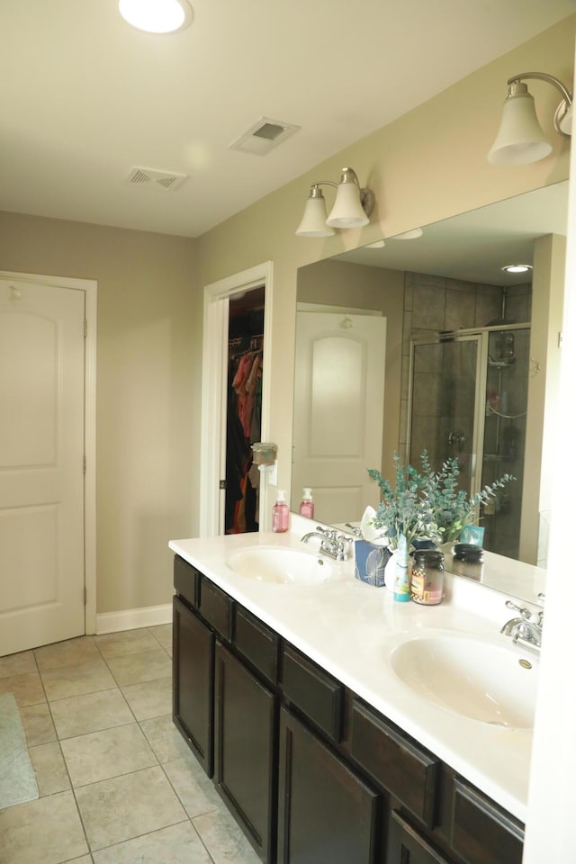 full bathroom with a sink, visible vents, a stall shower, and tile patterned floors