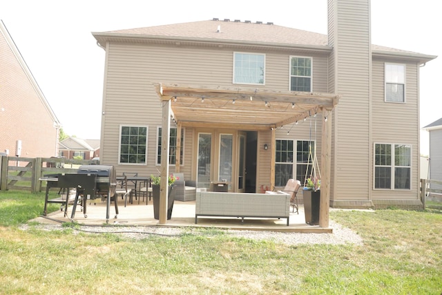 rear view of house with a patio, fence, a yard, a chimney, and an outdoor hangout area