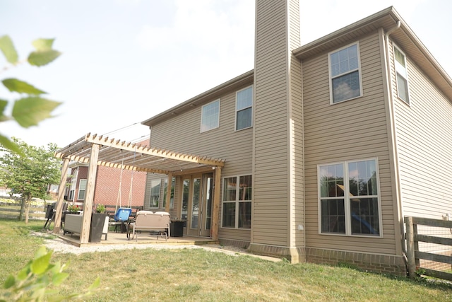 back of property with fence, a chimney, a pergola, and a patio area