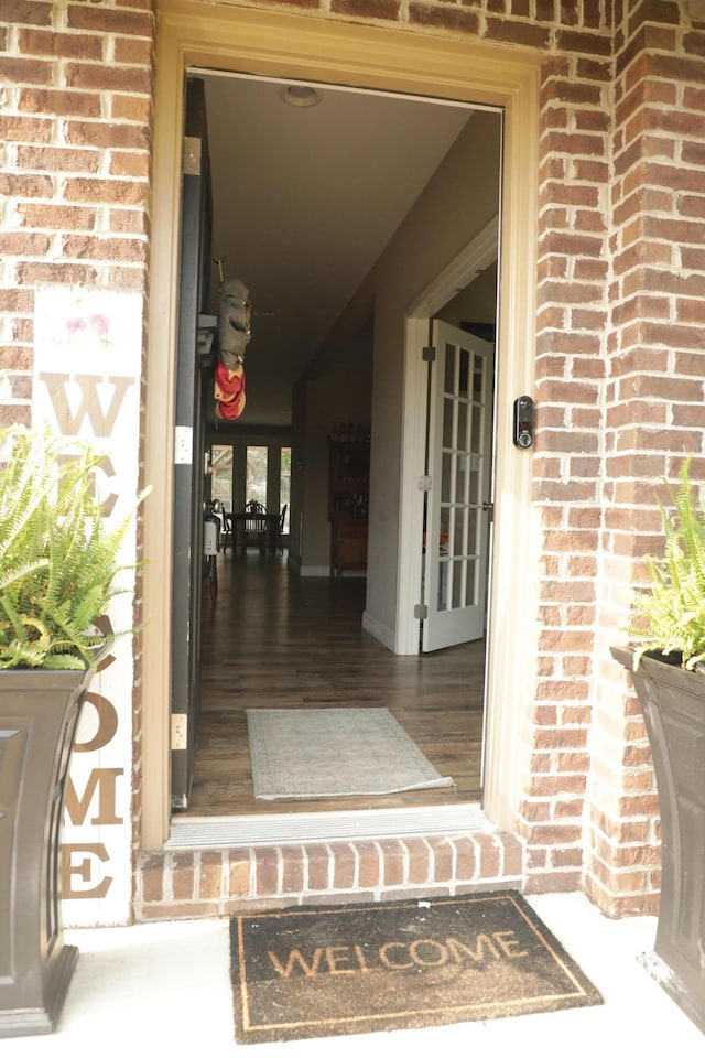 property entrance featuring brick siding