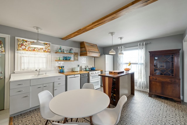 kitchen featuring white appliances, premium range hood, butcher block countertops, a sink, and beamed ceiling