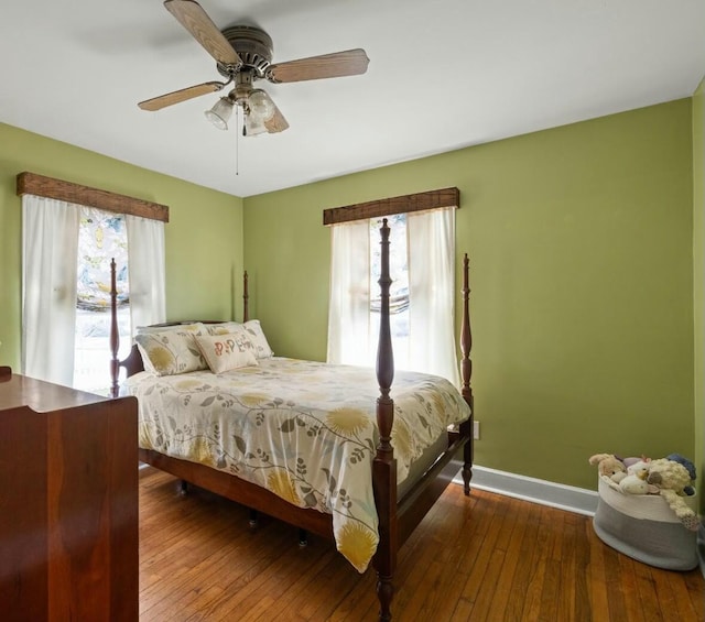 bedroom featuring baseboards, wood-type flooring, and ceiling fan