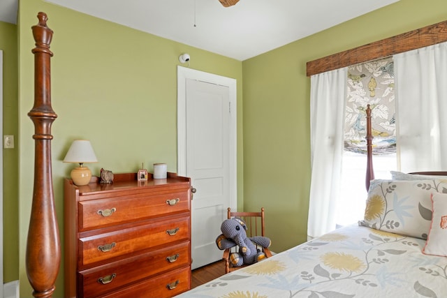 bedroom with access to outside and wood finished floors