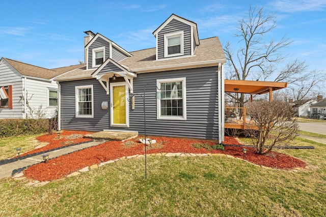 cape cod-style house with a front lawn and roof with shingles